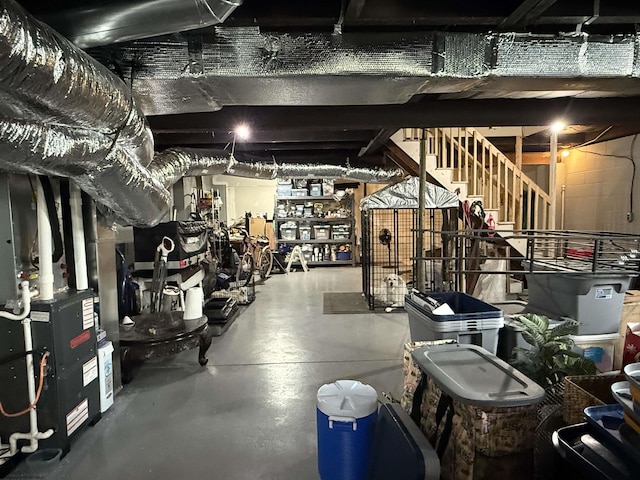 unfinished basement with heating unit and stairway