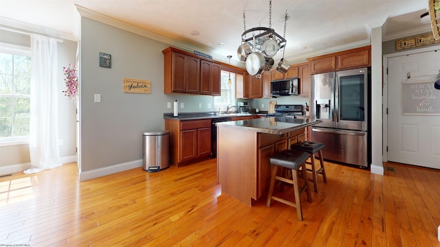 7 Mayberry Dr, Fairmont, WV 26554 - kitchen featuring range with gas stovetop, ornamental molding, a kitchen island, a kitchen breakfast bar, and stainless steel fridge with ice dispenser