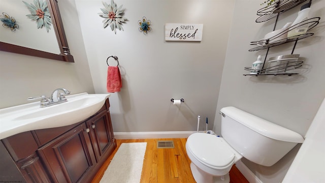 7 Mayberry Dr, Fairmont, WV 26554 - half bath with vanity, toilet, baseboards, wood finished floors, and visible vents