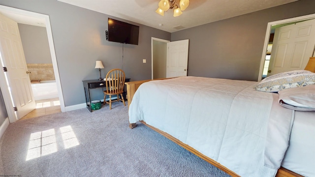 7 Mayberry Dr, Fairmont, WV 26554 - carpeted bedroom with baseboards, ensuite bathroom, a ceiling fan, and visible vents