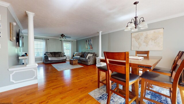 7 Mayberry Dr, Fairmont, WV 26554 - dining area featuring crown molding, decorative columns, light wood-style flooring, and a chandelier