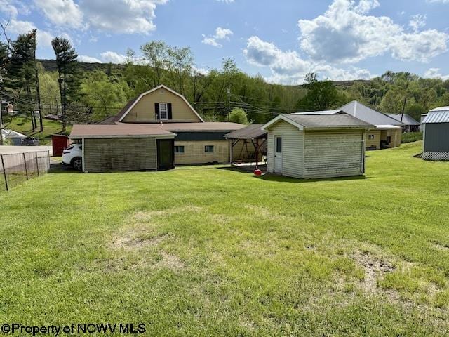 346 Parkway Ave, Anmoore, WV 26323 - rear view of property featuring fence, an outdoor structure, and a yard