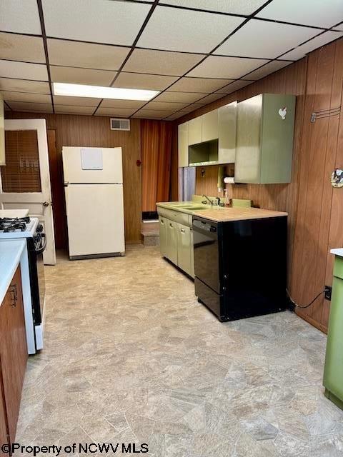 346 Parkway Ave, Anmoore, WV 26323 - kitchen featuring visible vents, range with gas stovetop, freestanding refrigerator, wood walls, and light countertops