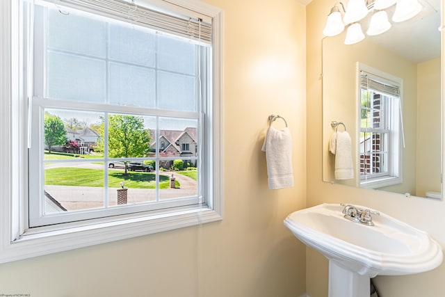 bathroom featuring a sink and a chandelier