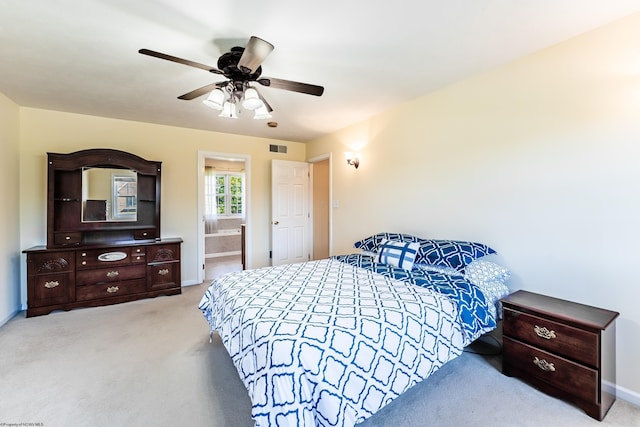 carpeted bedroom featuring baseboards, a ceiling fan, connected bathroom, and visible vents