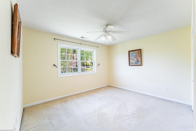 carpeted empty room with a ceiling fan, baseboards, and visible vents
