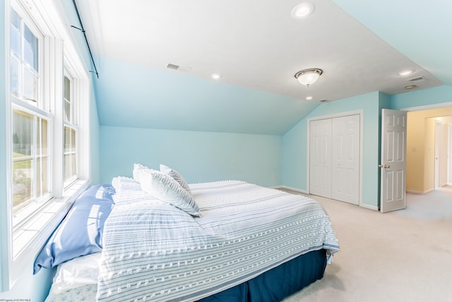 carpeted bedroom featuring visible vents, baseboards, a closet, lofted ceiling, and recessed lighting
