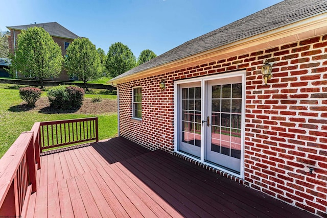 wooden terrace featuring a lawn