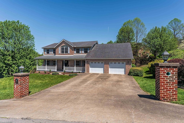 colonial house with a front lawn, brick siding, a garage, covered porch, and driveway