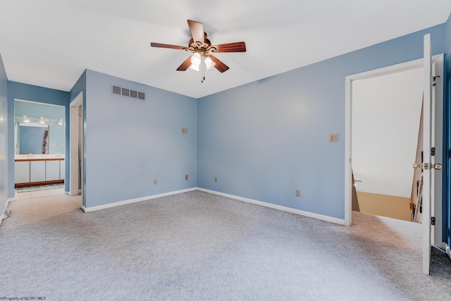 unfurnished bedroom with visible vents, baseboards, connected bathroom, a ceiling fan, and carpet