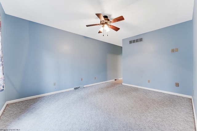 empty room featuring baseboards, ceiling fan, carpet flooring, and visible vents