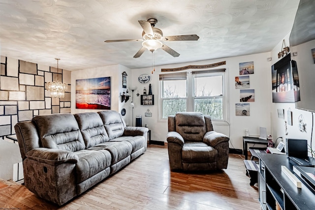 210 Rosedale Hill Rd, Maidsville, WV 26541 - living room featuring baseboards, wood finished floors, and ceiling fan with notable chandelier