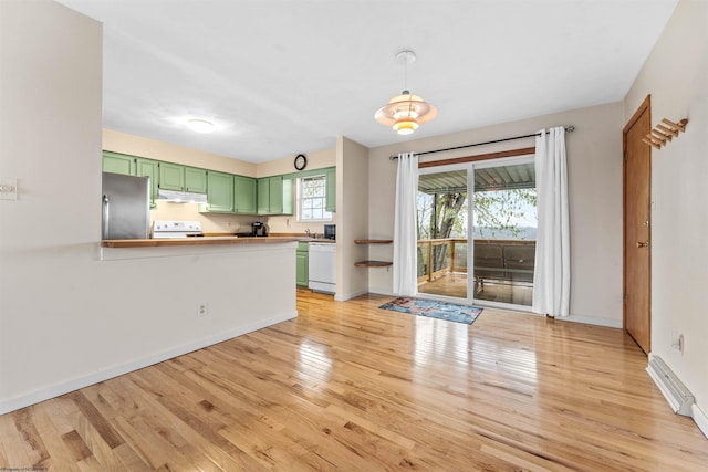 unfurnished living room featuring light wood-style floors, a sink, and baseboards
