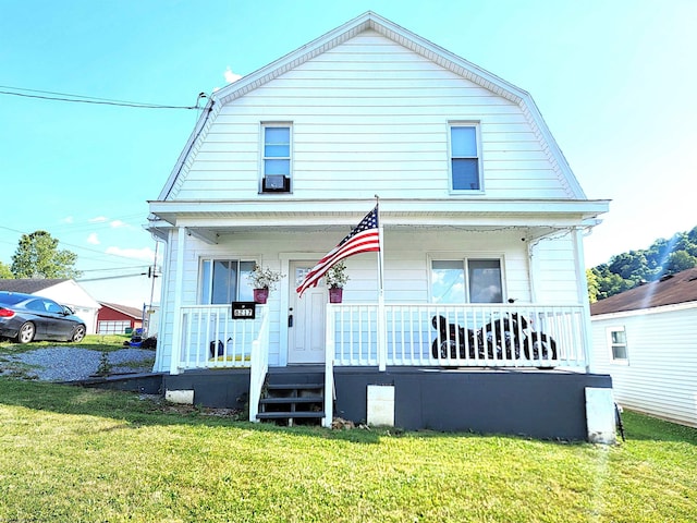 dutch colonial featuring a porch, a gambrel roof, and a front lawn