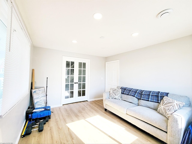 living area featuring baseboards, french doors, recessed lighting, and wood finished floors