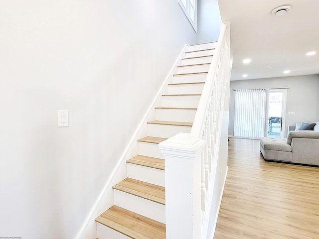 stairs with recessed lighting and wood finished floors