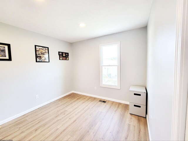 empty room with recessed lighting, baseboards, light wood finished floors, and visible vents