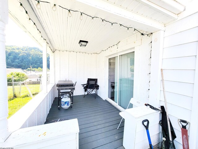 wooden deck featuring a grill