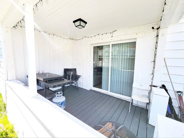 wooden deck with a grill