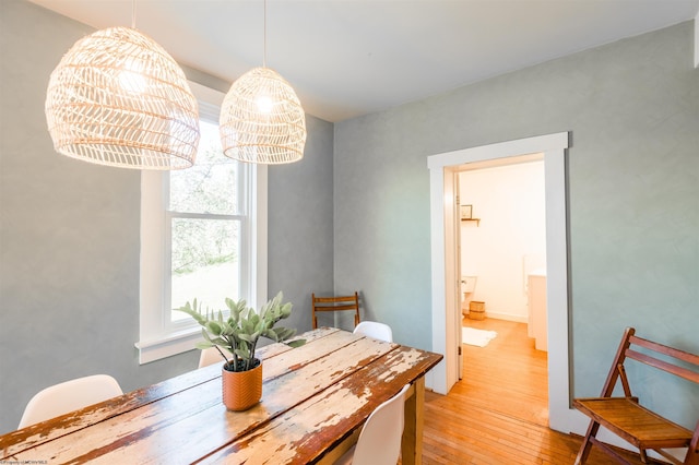 dining area featuring light wood-type flooring and a chandelier