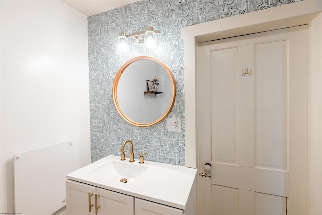 bathroom with vanity and wallpapered walls