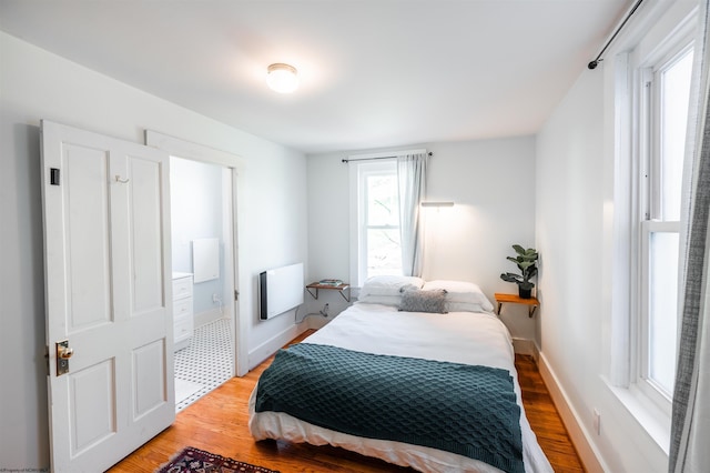 bedroom with baseboards and light wood-style flooring