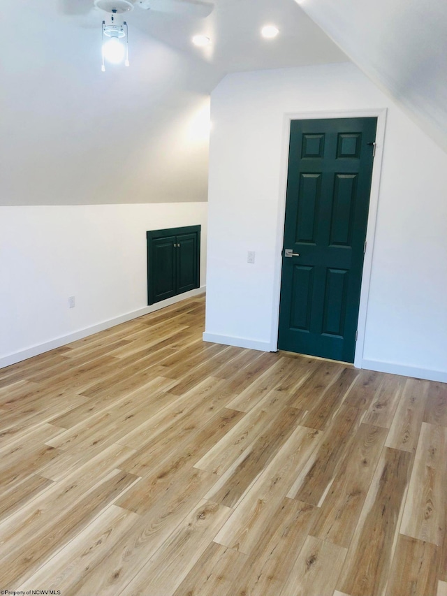 bonus room featuring light wood-style floors, recessed lighting, baseboards, and lofted ceiling
