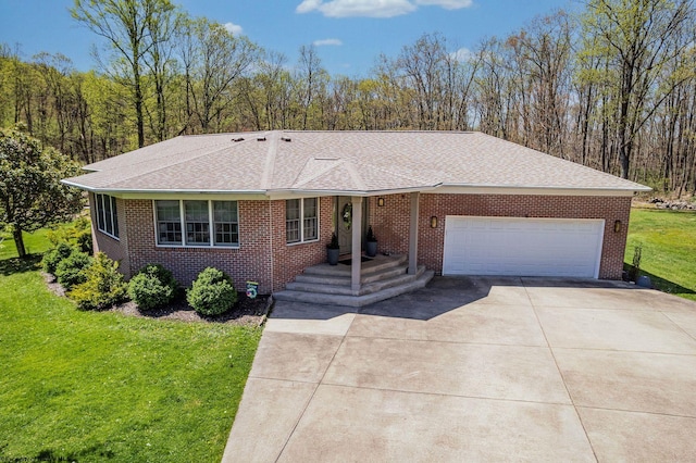 ranch-style house with an attached garage, concrete driveway, a front lawn, and brick siding