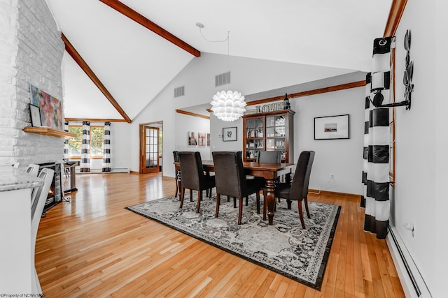 dining area with a notable chandelier, beam ceiling, baseboard heating, light wood-style floors, and visible vents