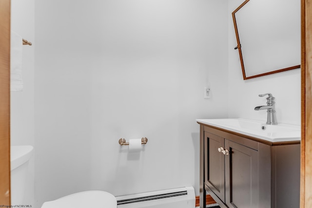 bathroom featuring vanity, toilet, and a baseboard radiator