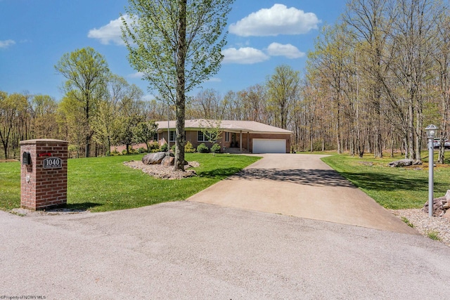 single story home with an attached garage, a front lawn, and concrete driveway