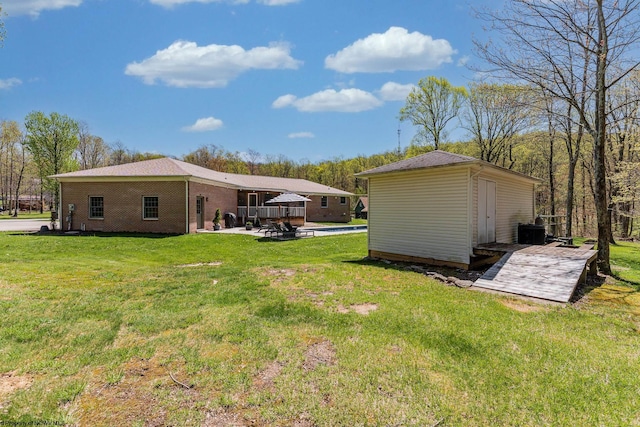 view of yard with a storage shed, a patio, and an outdoor structure