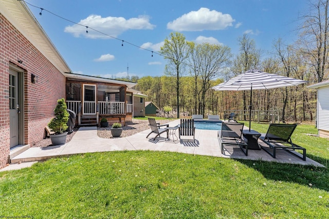 view of yard with a patio and an outdoor pool