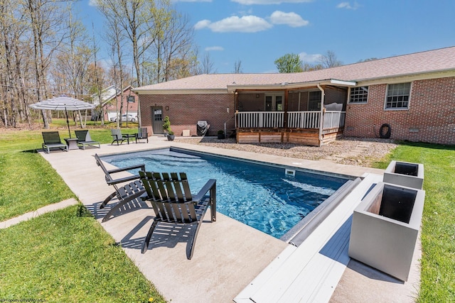pool featuring a lawn, a patio area, and french doors