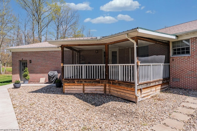 view of front of house featuring covered porch and brick siding
