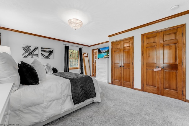 carpeted bedroom featuring crown molding and baseboards