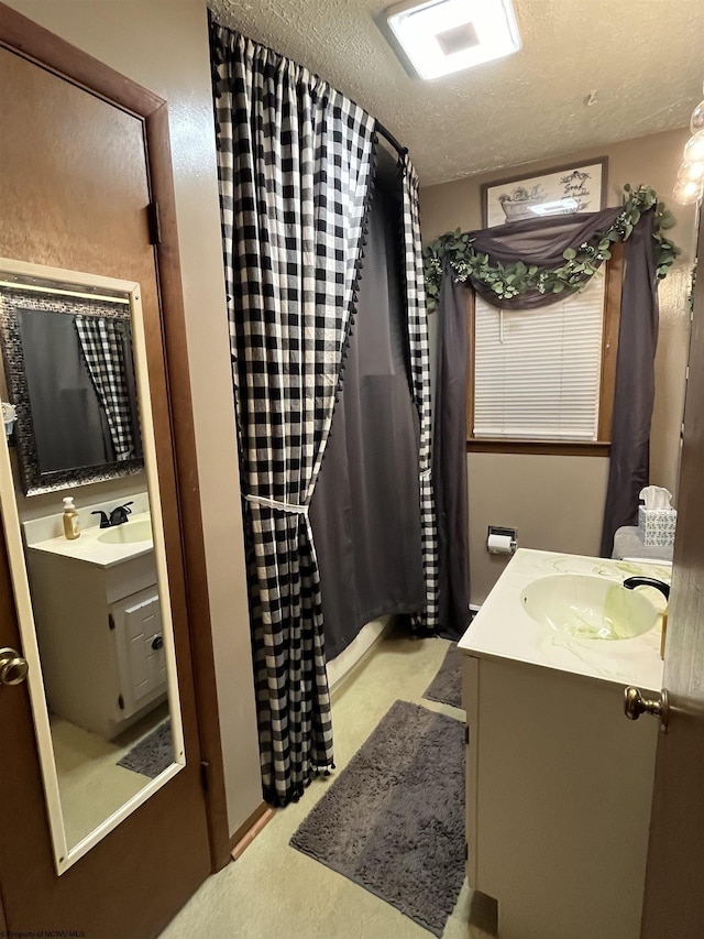 bathroom featuring vanity, a textured ceiling, and a shower with shower curtain