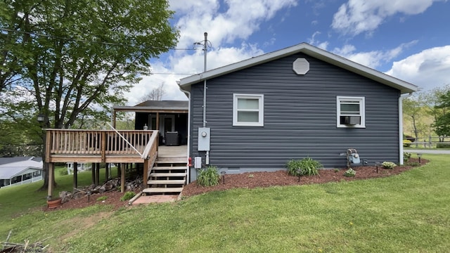 back of property with a deck, cooling unit, crawl space, a lawn, and stairway