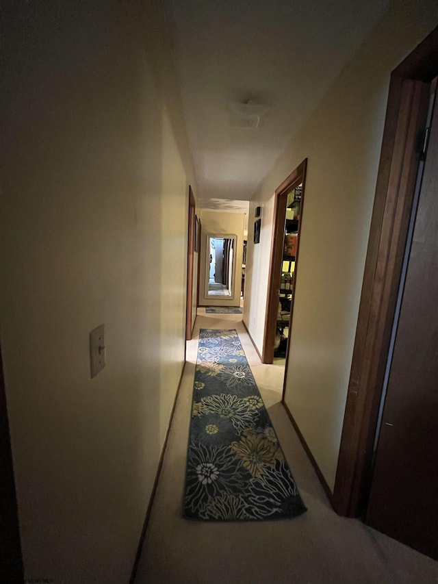 hall featuring light colored carpet