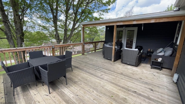wooden deck featuring grilling area, outdoor dining area, and an outdoor hangout area