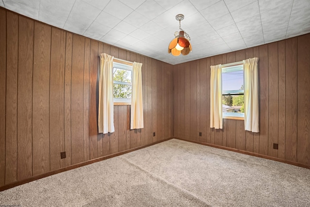 unfurnished room featuring carpet flooring and baseboards