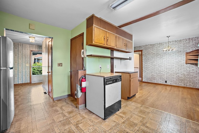 kitchen featuring freestanding refrigerator, brick wall, dishwashing machine, and open shelves