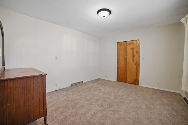 carpeted spare room with baseboards and visible vents