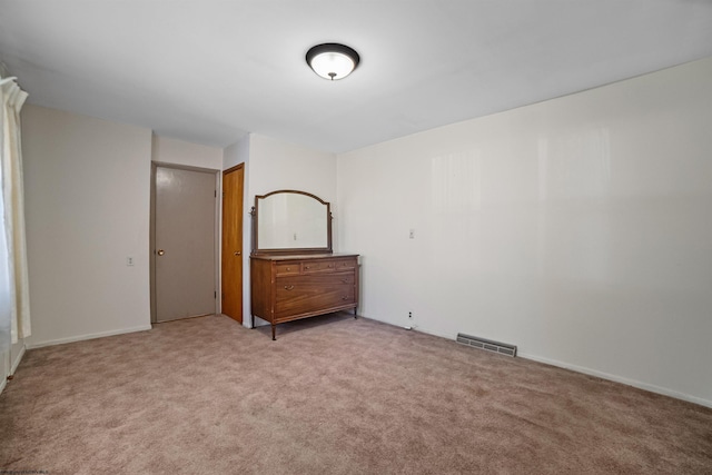unfurnished bedroom with carpet floors and visible vents