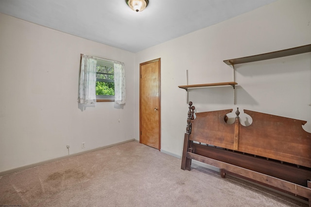 interior space featuring baseboards and carpet