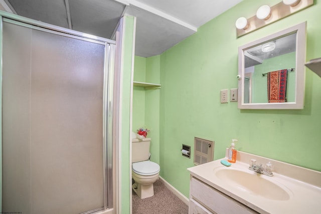 bathroom featuring vanity, toilet, baseboards, and a stall shower