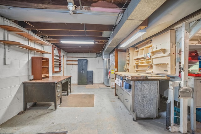 unfinished basement featuring heating unit and a workshop area