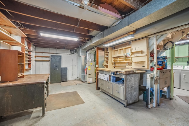 unfinished below grade area featuring independent washer and dryer and a workshop area