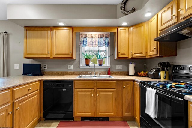 kitchen featuring a sink, light countertops, black appliances, and under cabinet range hood