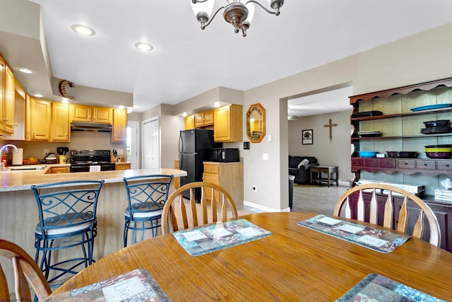 dining room with baseboards, recessed lighting, and light wood-style flooring